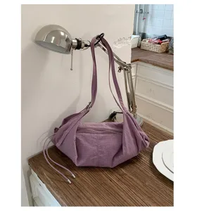 Detailed view of the casual purple canvas shoulder bag, perfect for daily commuting and school.