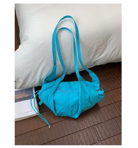 Detailed closeup view of a bright blue casual shoulder bag featuring wrinkled design.