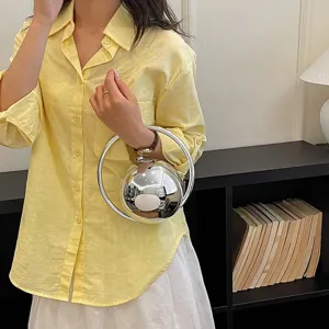Metallic ball handbag with unique ring handle, chic niche design for modern women commuting.