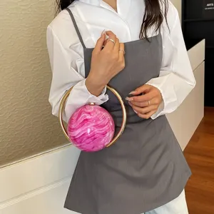 Unique round marbled resin evening clutch with gold ring handle for women commute fashion.