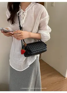 Black woven leather crossbody bag with chic strawberry charm for women fashion daily style
