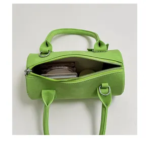 Green suede cylindrical handbag for women, stylish niche shoulder bag and crossbody baguette bag.