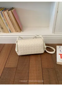 Detailed view of white woven crossbody bag, stylish retro shoulder bag for women daily fashion.