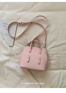 Schicke rosafarbene Damentasche, elegante Textil-Handtasche mit Schultergurt und modischem Design.