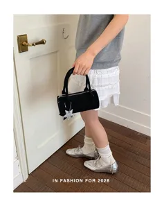 Korean style solid color handbag baguette bag for women, chic cylindrical shoulder bag with star charm.