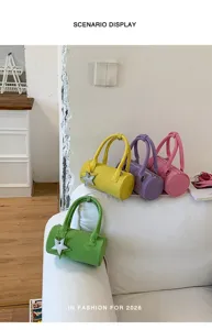 Stylish cylindrical handbag with star pendant, casual solid color design for daily fashion use.