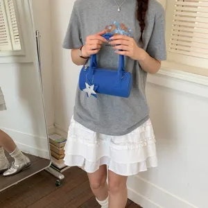 Korean style solid color cylindrical handbag for women, chic minimalist blue shoulder barrel bag.
