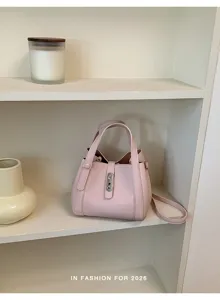 Chic bolso cubo de cuero rosa, bolso cruzado versátil con elegante cierre de metal elegante.