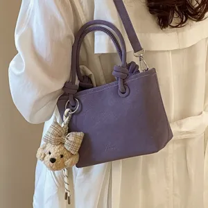 Stylische violette Beuteltasche für Damen, vielseitige Umhängetasche mit süßem Hundeanhänger.