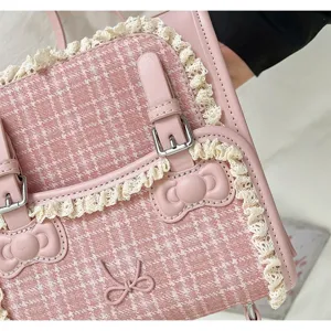 Pink plaid lolita backpack with lace trim, cute bow details and double buckle straps.