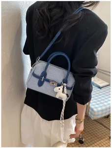 Summer commuting contrast denim shoulder crossbody pillow bag detail view with chic pendant.