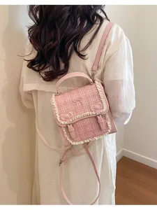 Pink tweed mini backpack detail featuring cute lace trim and bows, perfect for daily wear.