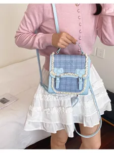 Detail shot of the light blue plaid mini backpack with cute lace trim and bow decorations.