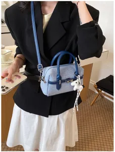 Stylish denim contrast shoulder bag for women, chic crossbody pillow bag with cute horse charm.