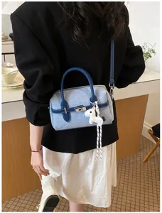 Denim cross-body shoulder bag for women, stylish contrast color handbag with chic horse charm.