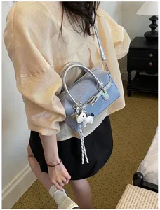 Denim shoulder handbag for women, stylish color block cross body pillow bag with charm.