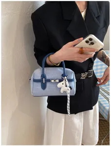 Blue denim contrast handbag for women summer commuter stylish crossbody pillow bag with charm.