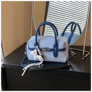 Denim shoulder crossbody pillow bag for women, stylish contrast color handbag with cute horse charm.