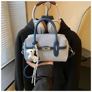 Cross-border fashion denim handbag with leather trim, metal lock and stylish pillow design.