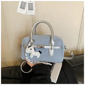 Chic denim silver hardware handbag, fashionable top handle shoulder crossbody bag.