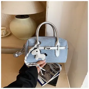Chic denim and silver colorblock shoulder handbag with cute horse charm for summer commuting.