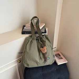 Casual green bucket bag with cute bear pendant, large capacity multifunctional commuter bag.