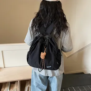 Black drawstring backpack detail, casual daily fashion school bag with cute bear charm.