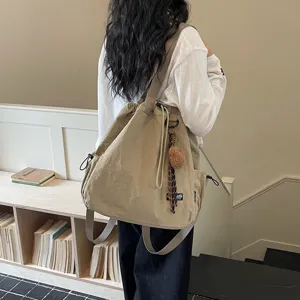 Casual khaki bucket backpack for women, multi-functional canvas shoulder bag with drawstring.