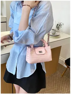 Pink woven crossbody bag for women, stylish shoulder handbag with top handle and chain strap.