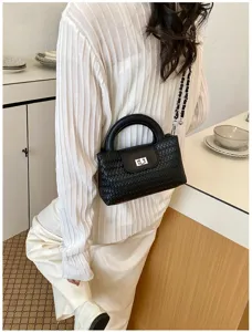 Close-up view of black woven leather handbag featuring metal lock and chic chain strap.