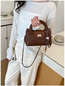 Woven design handbag detail featuring chic chain strap and elegant top handle for women.