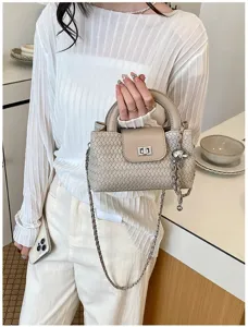 Woven leather mini handbag detailed view, chic chain strap and secure turn-lock closure.