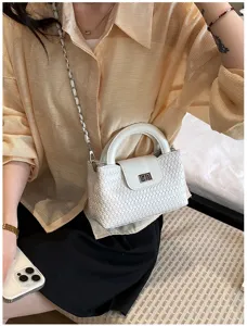 Chic white woven top handle bag featuring a stylish chain strap and elegant clasp closure detail.