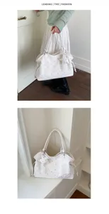 Detail view of large capacity white polka dot tote bag with cute charms and shoulder strap.