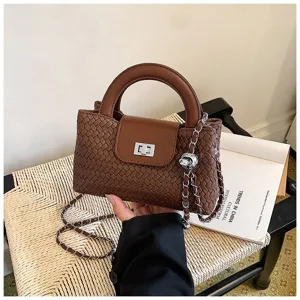 Detailed view of the stylish brown woven leather handbag showcasing intricate craftsmanship and hardware.