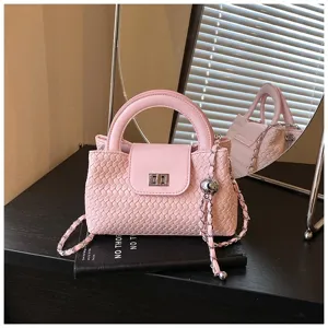Pink woven top-handle crossbody bag with elegant chain strap and secure turn-lock detail.