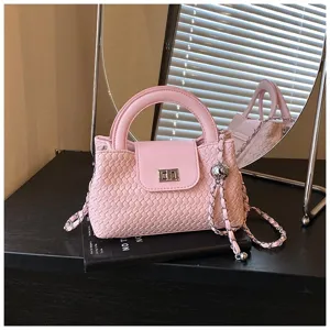 Pink woven top handle crossbody bag with chain strap and turn-lock closure stylish.