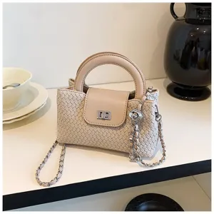 Compact woven top-handle crossbody bag with textured leather, metal chain strap, and sleek flap lock.