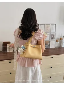 Elegant vintage-style shoulder bag detail showcasing premium leather texture and chic design.