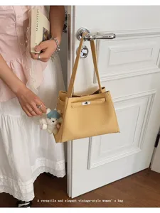 Vintage yellow leather women shoulder bag, elegant handbag with top handle and cute bear charm