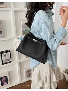 Versatile black leather shoulder bag with chic metal lock closure for daily commute.
