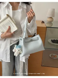 Korean style light blue fashion shoulder tote bag with elegant lock design and cute bear pendant.