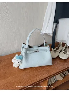 Korean style vintage blue handbag PU leather tote bag with metal lock and cute bear pendant.