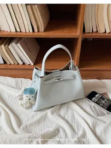 Elegant light blue leather handbag for women, versatile shoulder tote bag with chic design.