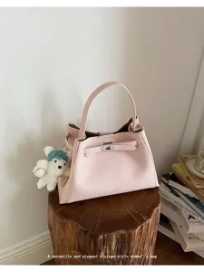 Pink leather handbag for women, elegant top handle shoulder bag with vintage style and charm.