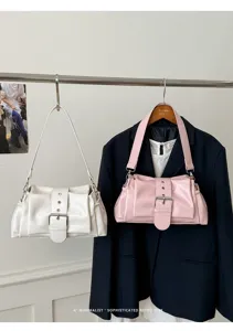 Detailansicht der stilvollen Lackleder Schultertasche mit Schnalle, elegantes minimalistisches Design.