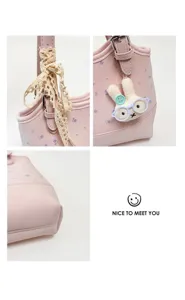Close-up detail shot of pink floral tote bag, showing cute bunny pendant and lace strap.