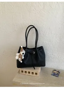 Black woven tote bag for women, stylish leather bucket shoulder bag with cute bear pendant for daily commute.