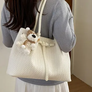 Chic woven tote bag for women, large capacity shoulder underarm bag with cute plush pendant.