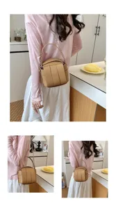 Detailansicht der stylischen geflochtenen Eimer Tasche mit Kettengriff und Trageriemen im Alltag.